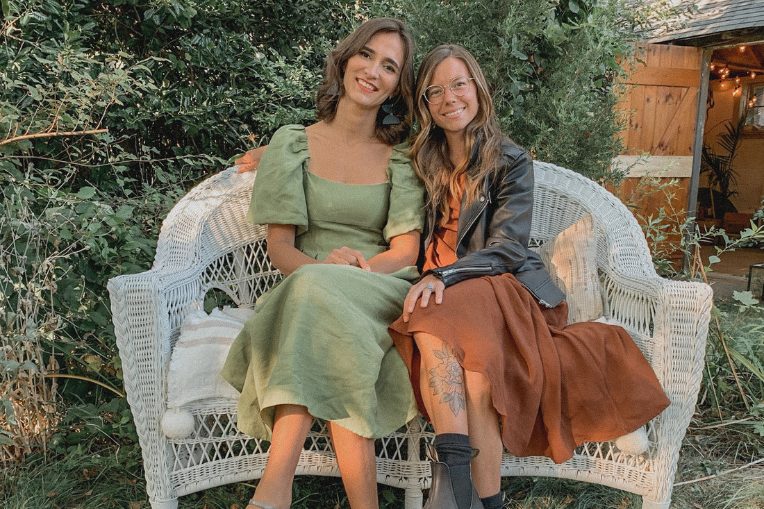 An image of two artist friends sitting together on bench