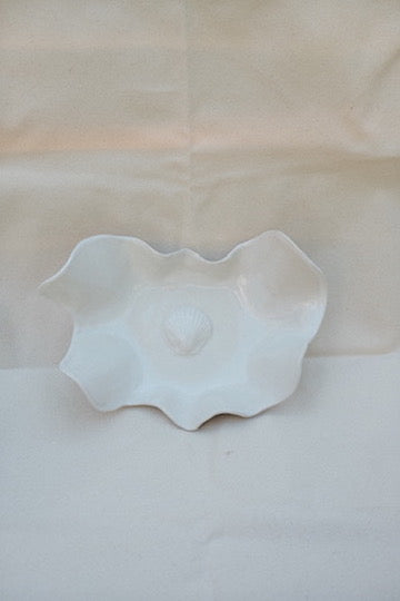 White ceramic bowl on a beige fabric background